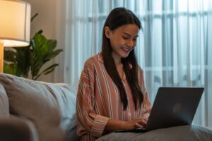 woman using a laptop looking for marketing career opportunities