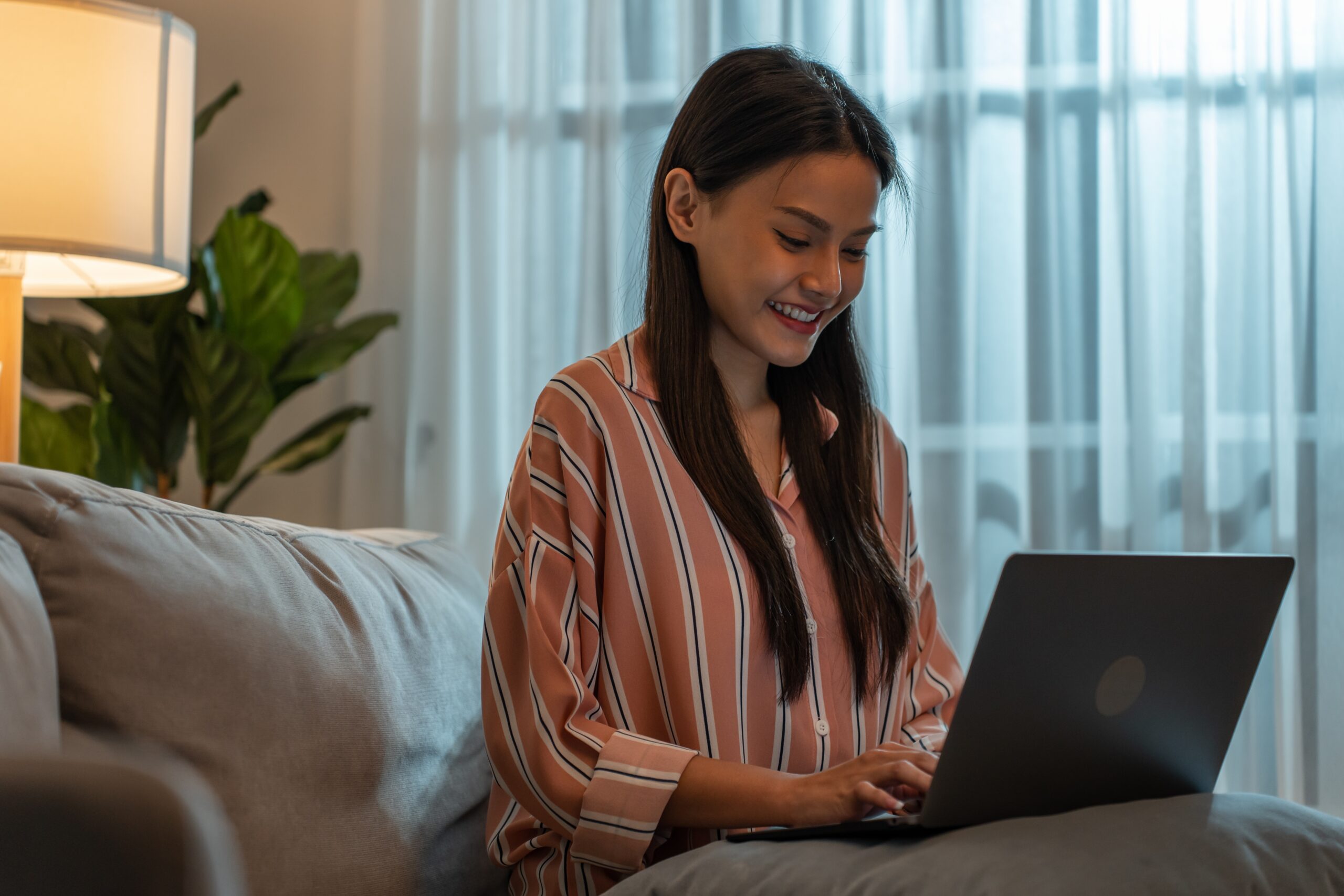 woman using a laptop looking for marketing career opportunities